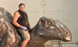 Andre Freitas Sits on Mother Dinosaur Sculpture for Fernbank Museum Atlanta, GA Front Plaza Dinosaur Sculpture Fountain